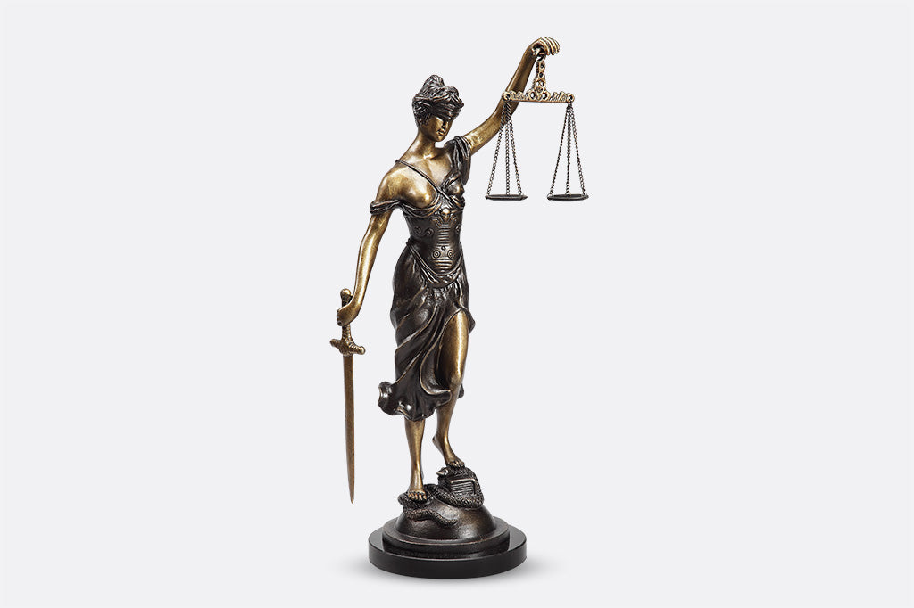 Classic office sculpture of lady justice, complete with scales and sword