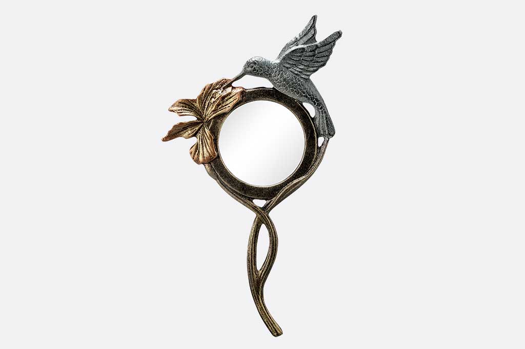 handheld magnifying glass with flower and hummingbird motif