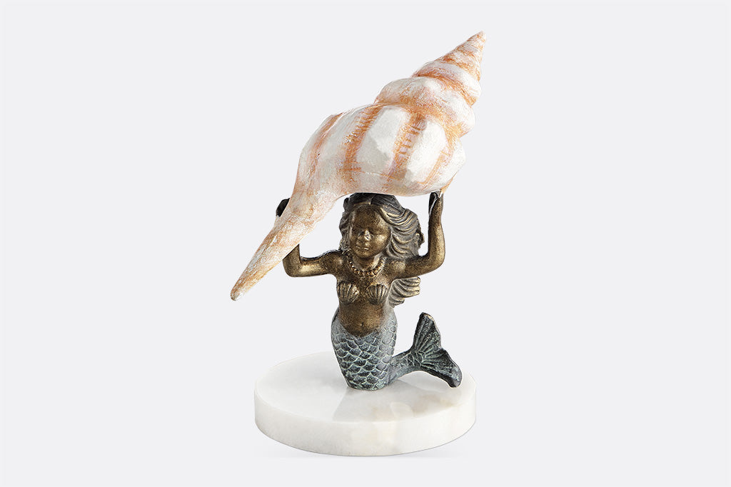 desk sculpture of kneeling mermaid holding pink shell over her head
