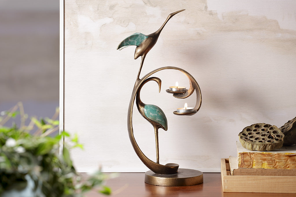home decor mini sculpture of two cranes with verdi patina - shown with base and swooping curl that holds two tea lights