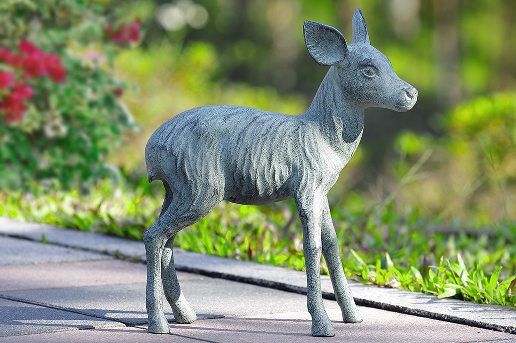 zinc finish fawn sculpture shown on garden path