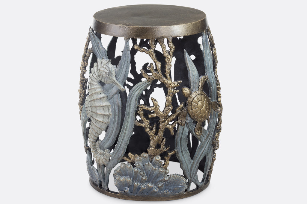 cast metal garden stool with solid seat, design of tidal animals: kelp, coral, turtle, seahorse in various finishes of green, blue, bronze, and zinc