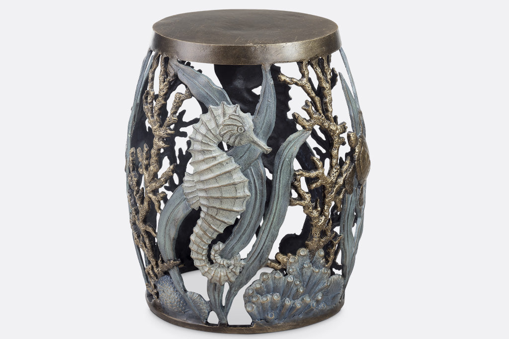 cast metal garden stool with solid seat, design of tidal animals: kelp, coral, turtle, seahorse in various finishes of green, blue, bronze, and zinc
