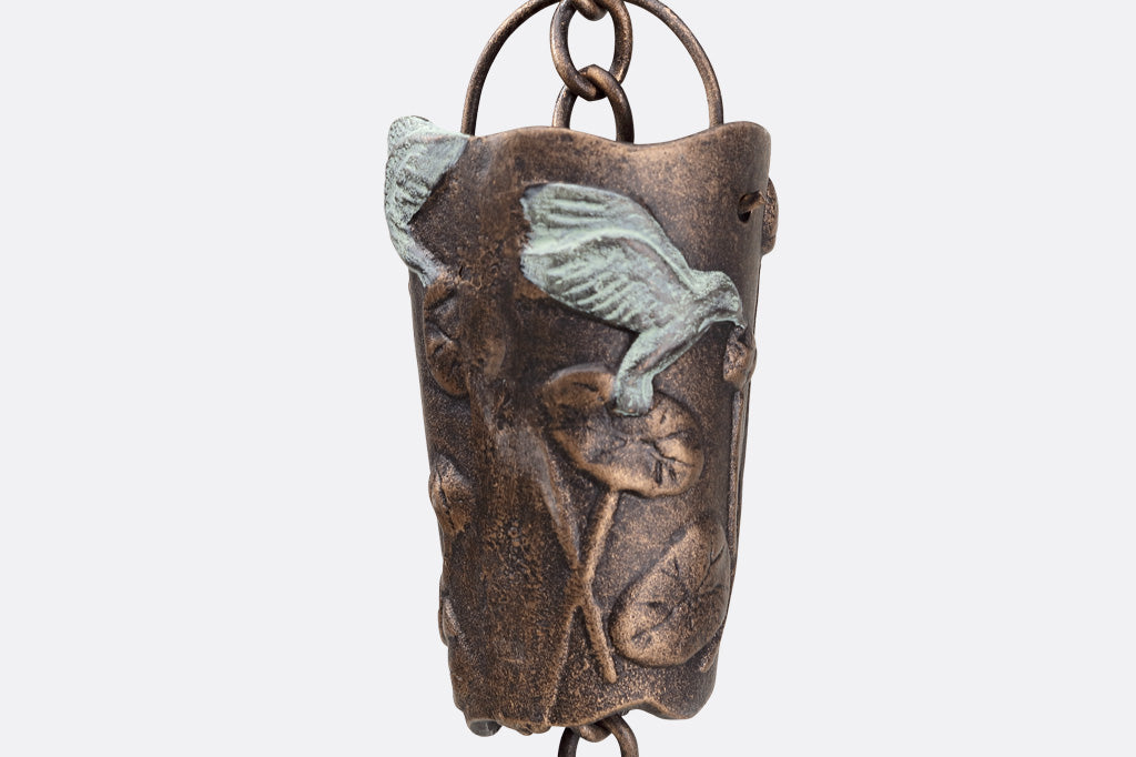 closeup view of watercup with hummingbird and leaf motif