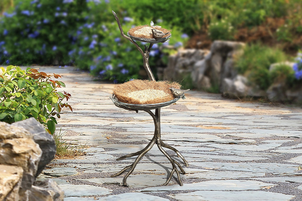 two tier bird feeder/planter shown in a garden