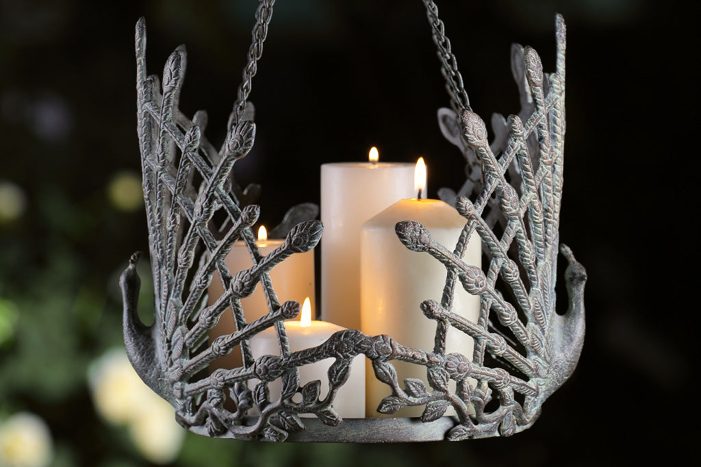 cast metal hanging pot holder with two peacocks in full relief sculpting with outspread feathers