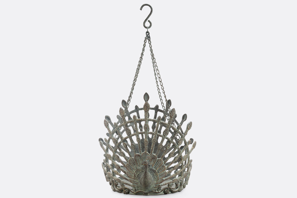 cast metal hanging pot holder with two peacocks in full relief sculpting with outspread feathers