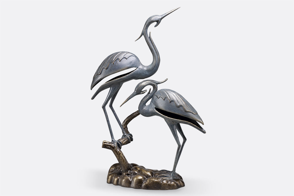 cast metal modern crane sculpture