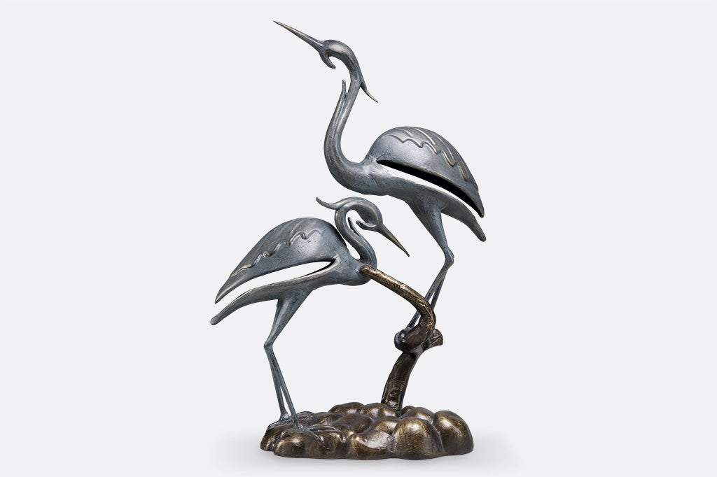 cast metal modern crane sculpture