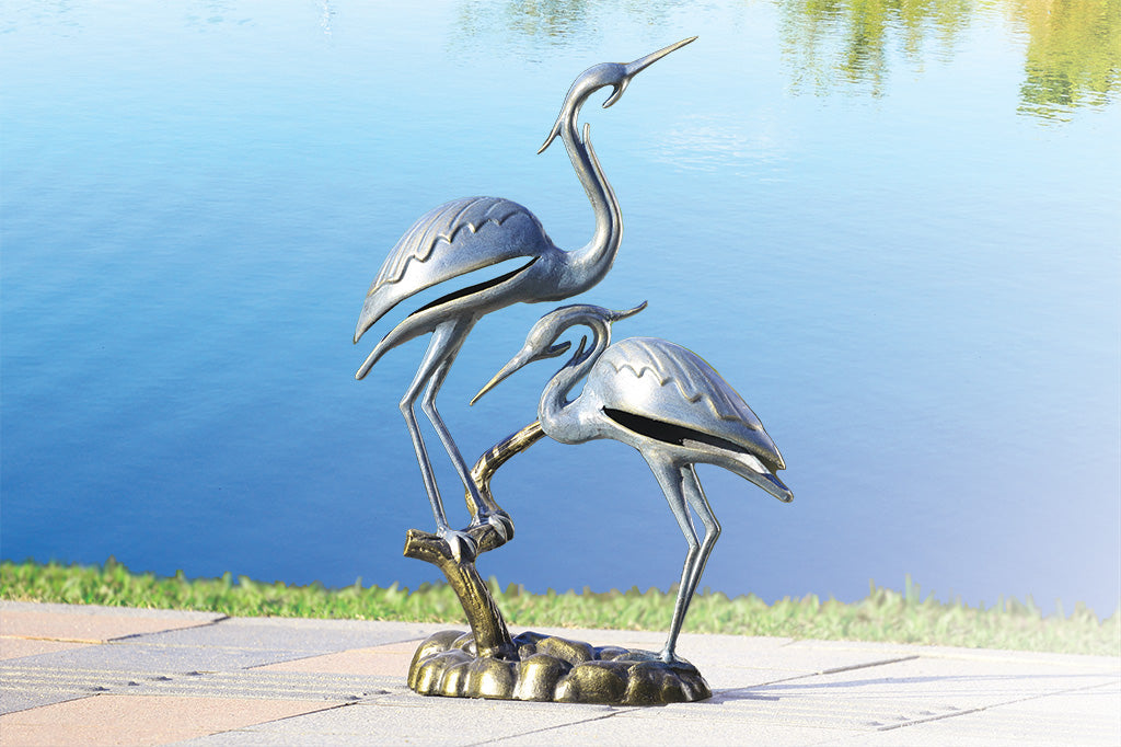 cast metal modern crane sculpture set by waters