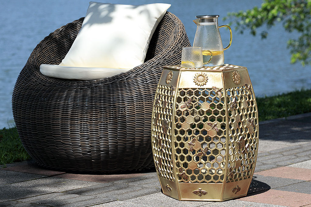 All Abuzz Garden Stool holds pitcher and glass of lemonade outdoors by a papasan by a lake