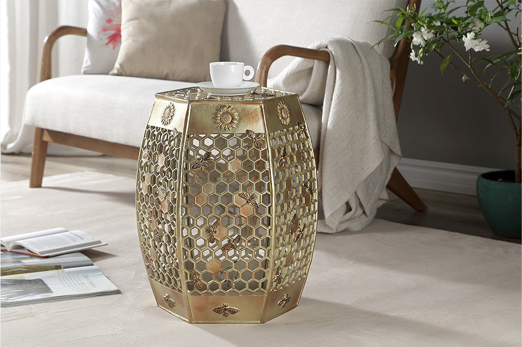 All Abuzz Garden Stool shown in contemporary style living room on carpet, nearby are loveseat, tree, and magazines