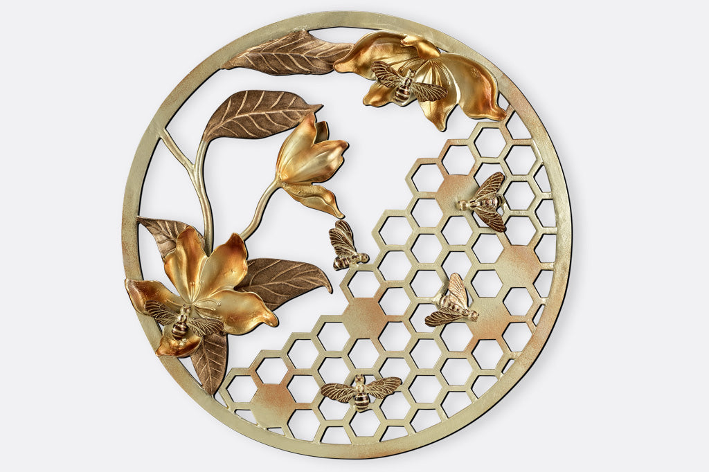 Circular wall plaque in golden cast metal finish featuring bees, honeycomb and blossoms