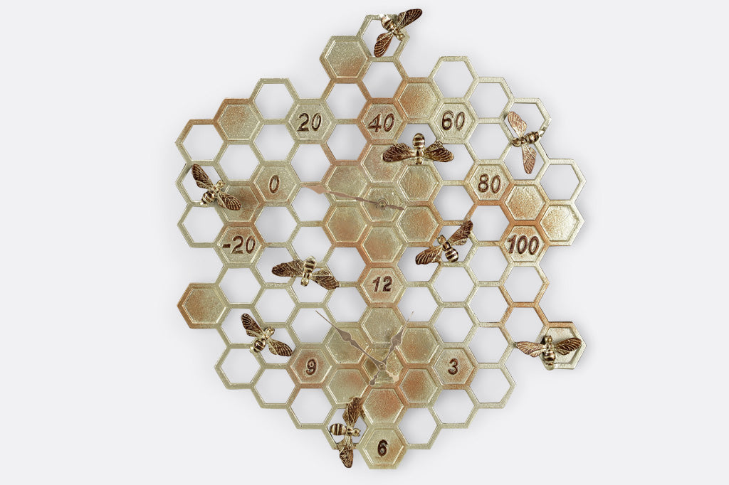 Wall clock and thermometer for outdoor or indoor. Shown on honeycomb pattern hexagon with accent sculpted bees, all in golden finish with pinky red accents