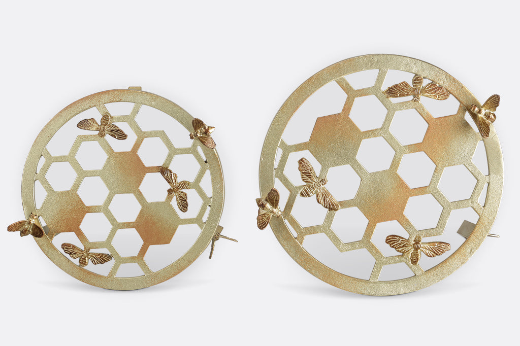 Two plant stands showing honeycomb and bee motif, one large and one small, top view