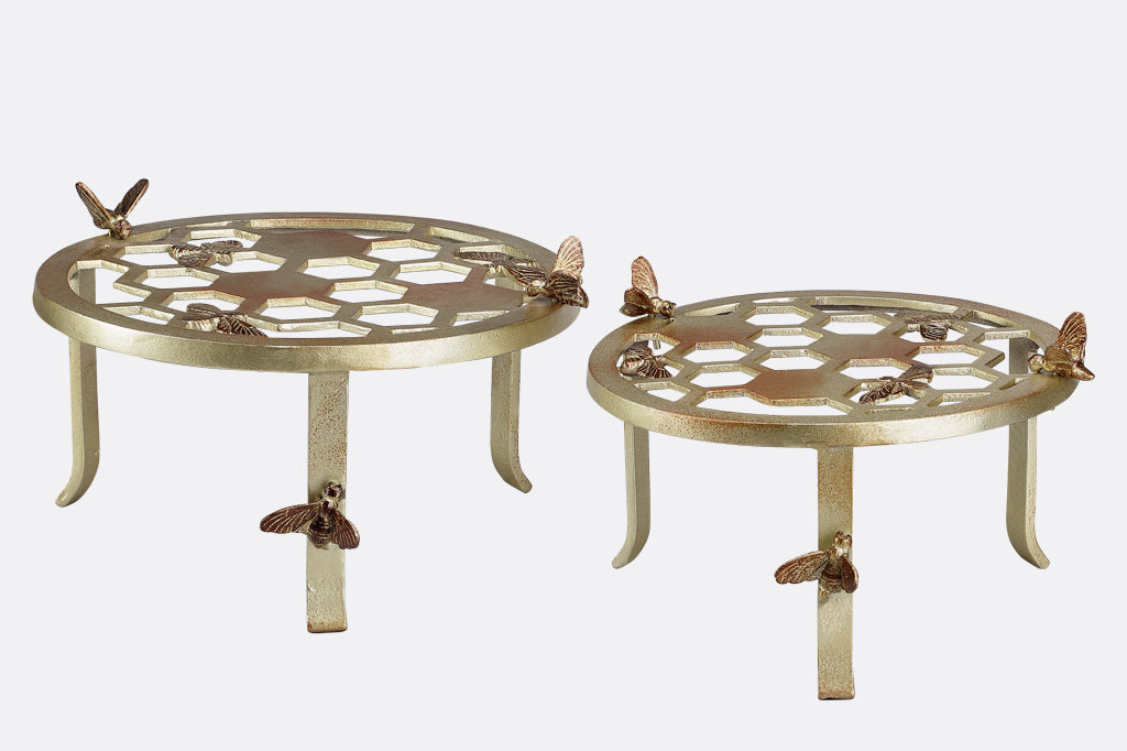 Two plant stands showing honeycomb and bee motif, one large and one small