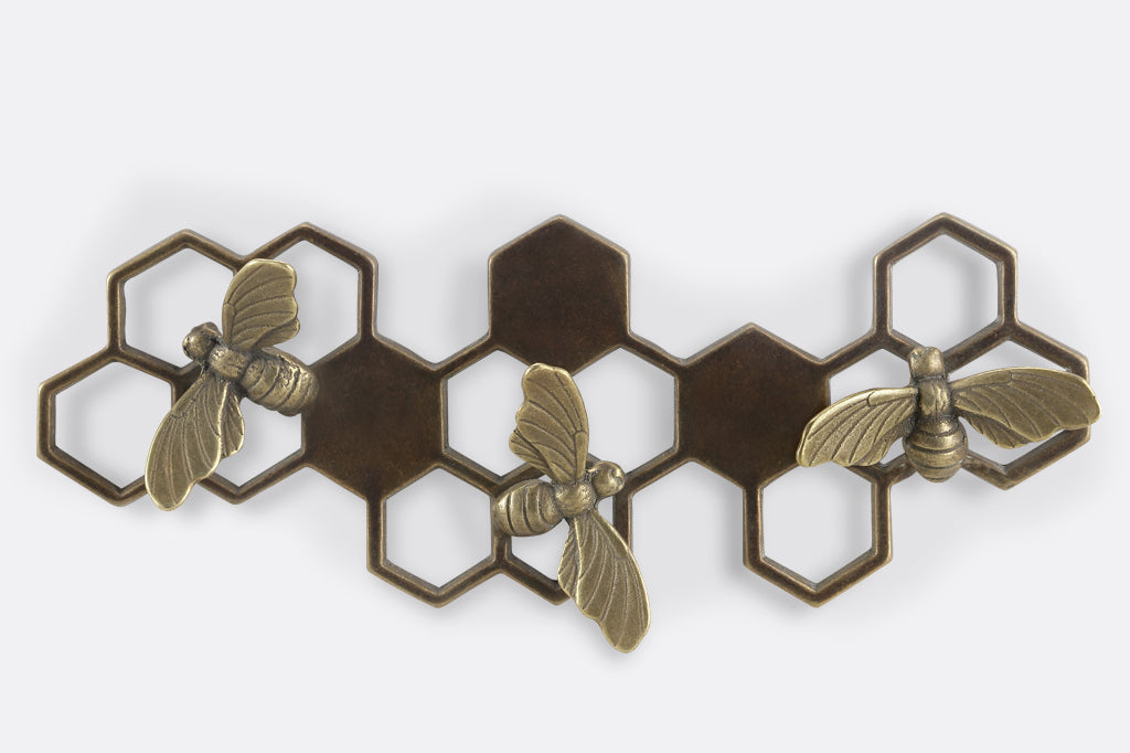Brass wall art key hook showing honeycomb and bee motif