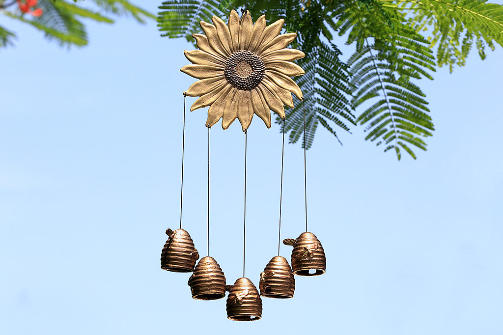 Sunflower and honeybee theme wind art, 5 pendant beehives - shown suspended form mimosa tree with blue sky in background