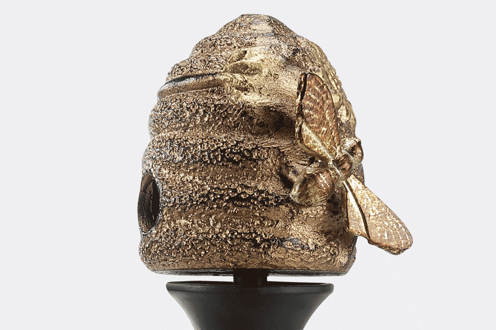 cast metal beehive with sunflower and bee hose guard