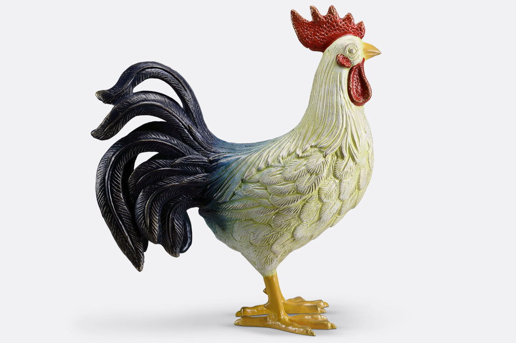 large and colorful cast metal rooster sculpture shown looking to the right: blue-black tail feathers and red crest