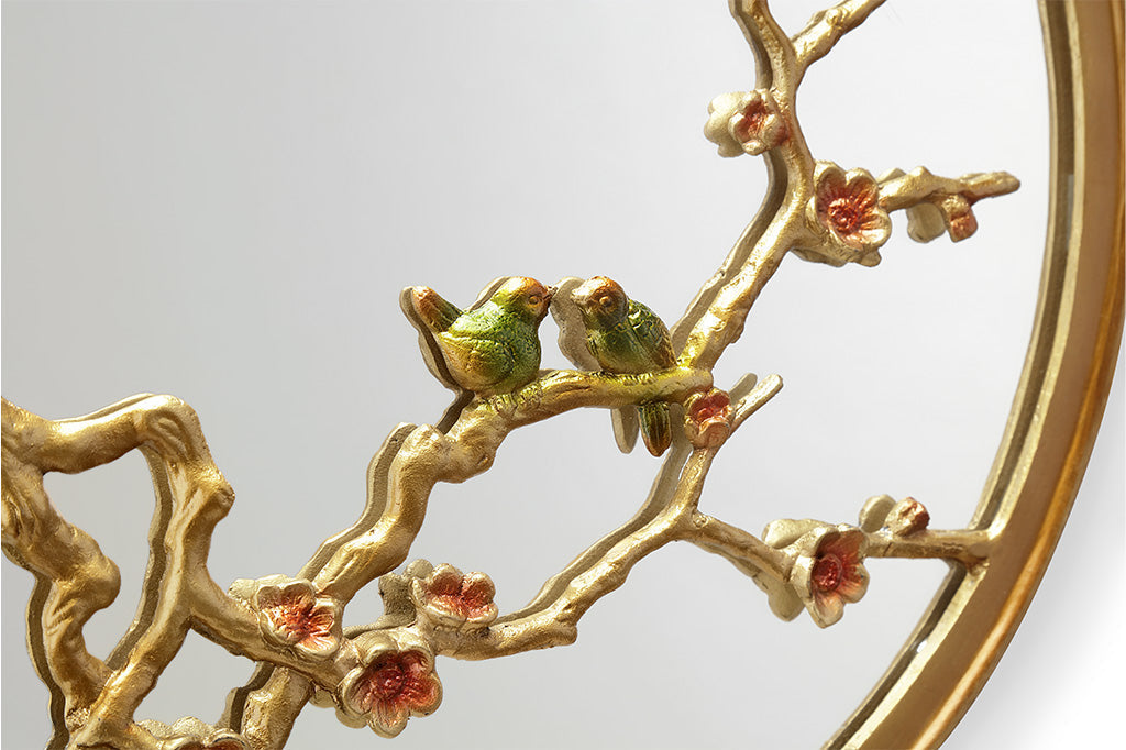 cast metal gold mirror with blossom branches and pink blooms and two small birds on branch