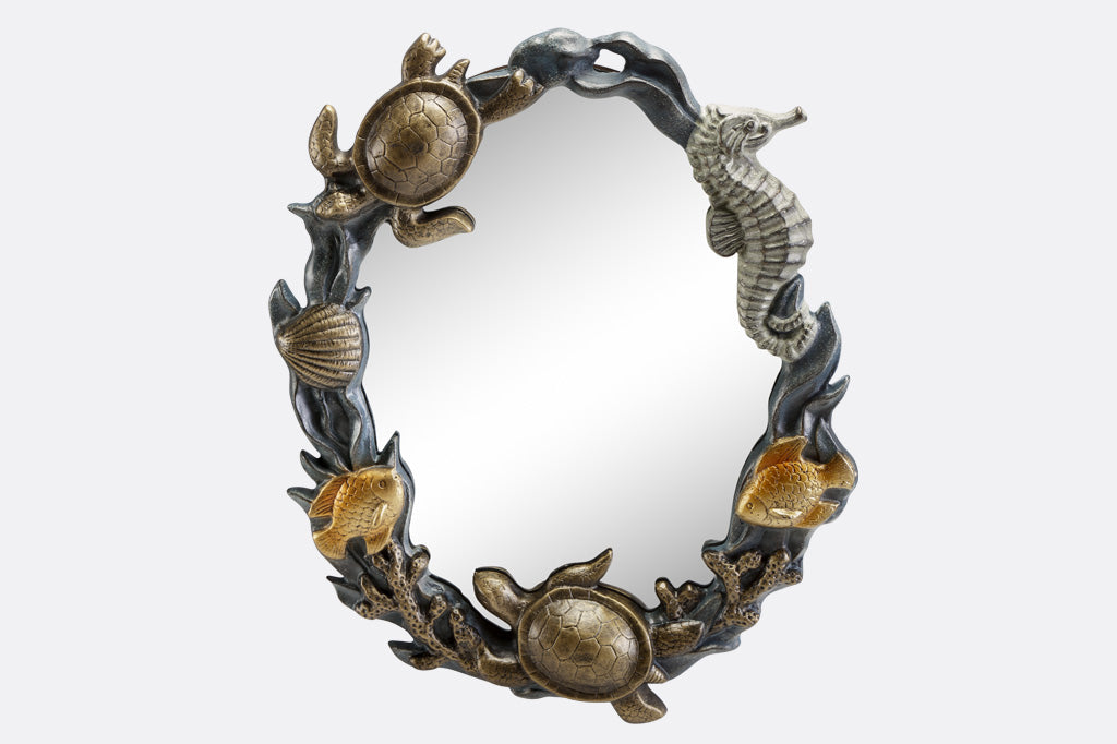 cast metal mirror with sea creatures and shells on rim, seahorse, turtle, fish and coral surrounding the mirror
