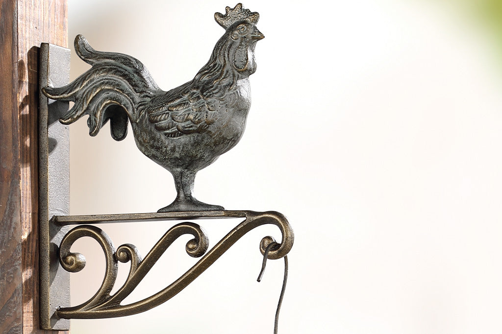hanging planter basket suspended from rooster shaped wall hanger