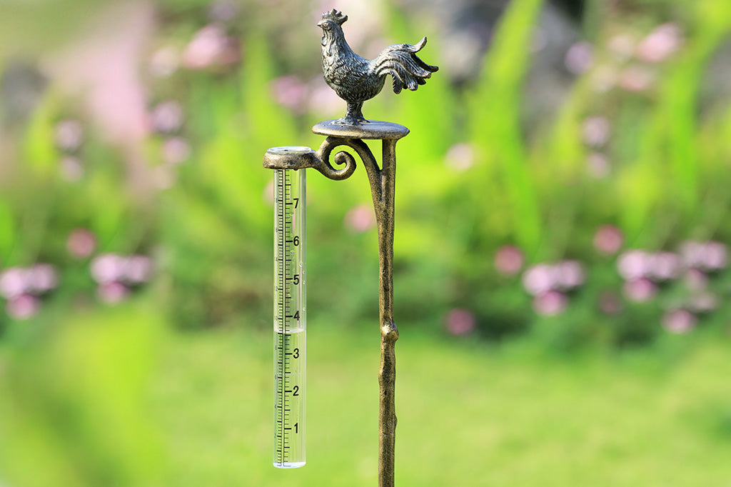 Rooster finial on staked rain catcher shown in garden
