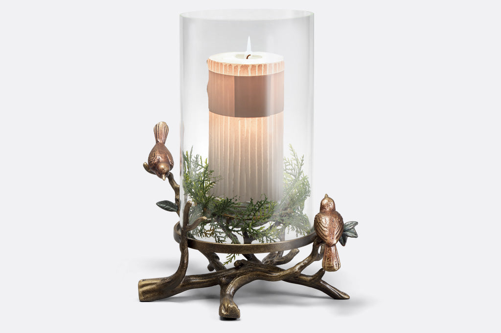 Tri-Finish Sparrows & Nest Candleholder is shown with a seasonal candle and faux greenery display