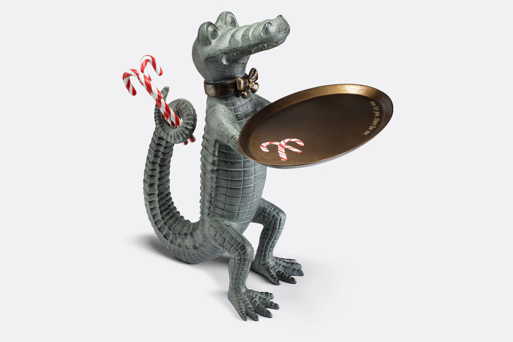 Holiday décor: Standing Crocodile dressed as a butler holds a serving tray whilst hiding candy canes behind its back.
