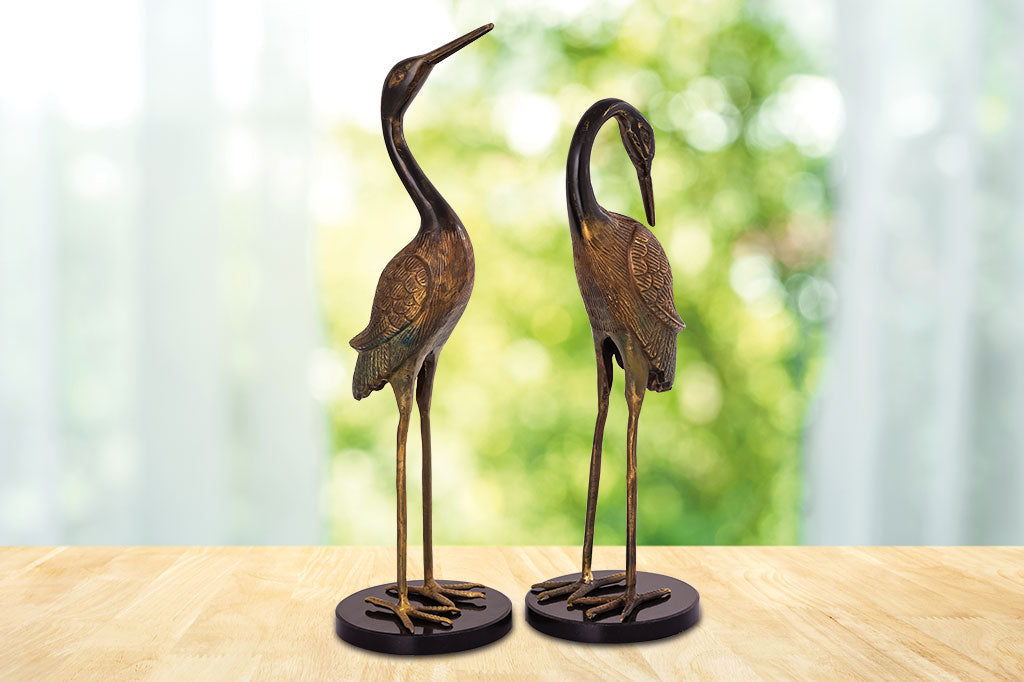 pair of crane table sculptures with marble base