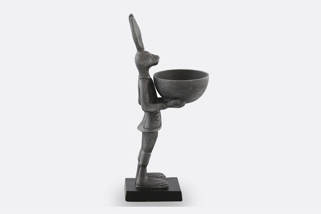 cast metal bunny holding a bowl sculpture