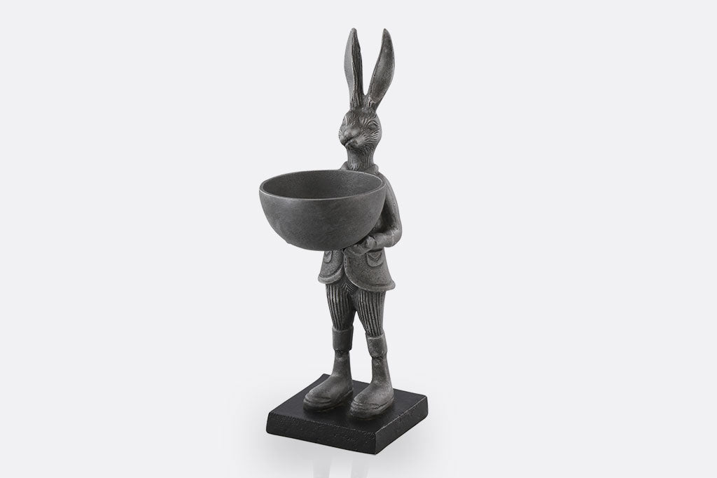 cast metal bunny holding a bowl sculpture