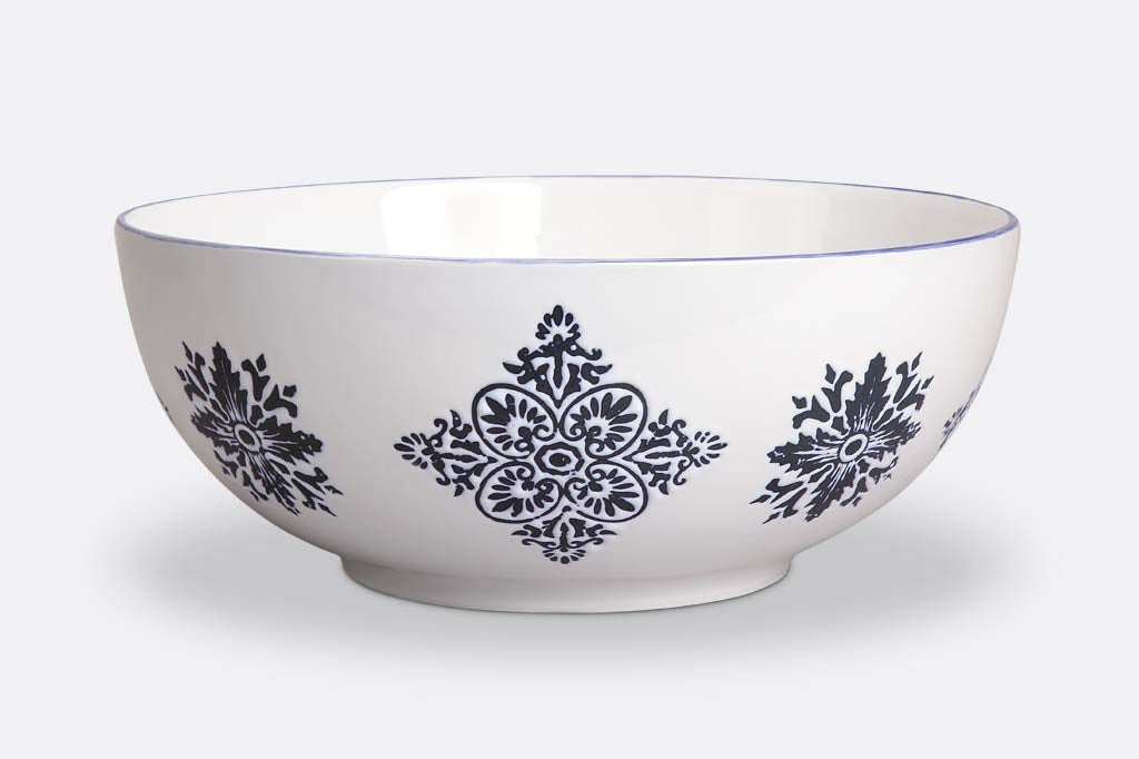 white ceramic bowl with blue mediterranean glazed print; blue rim