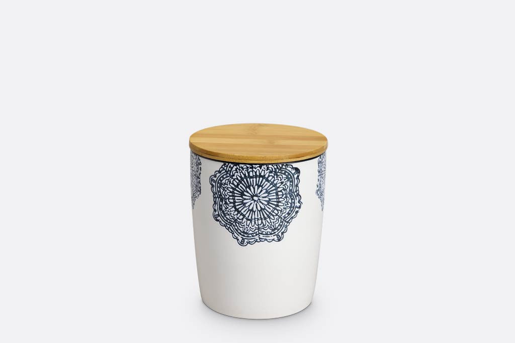 canister of white ceramic with blue mediterranean glazed print and blue rim; has wood lid