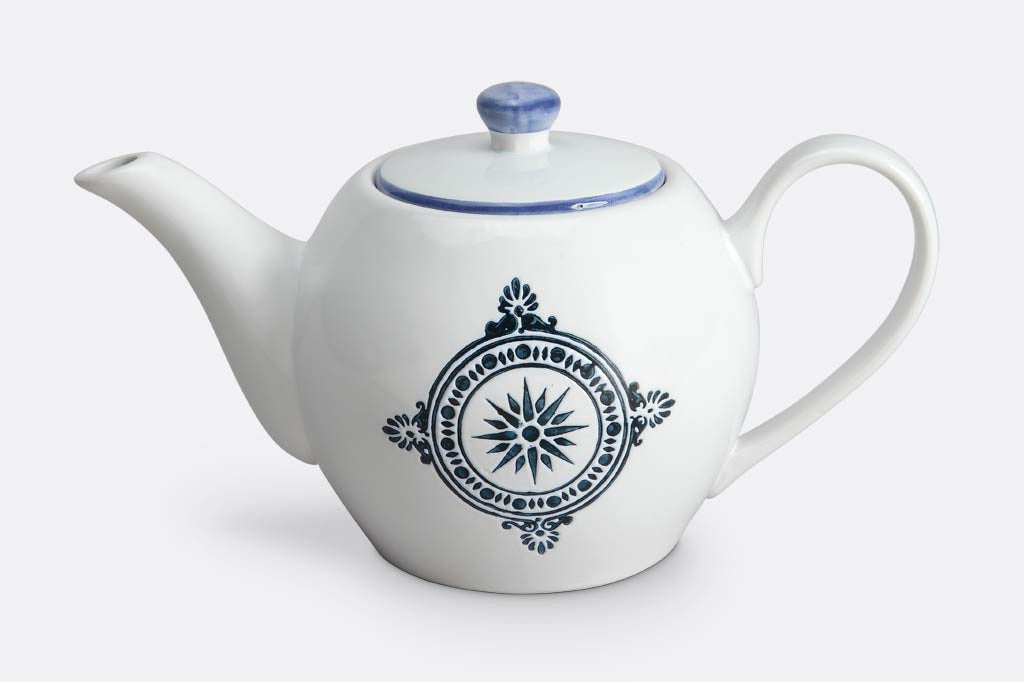 teapot of white ceramic with blue mediterranean glazed print and blue rim