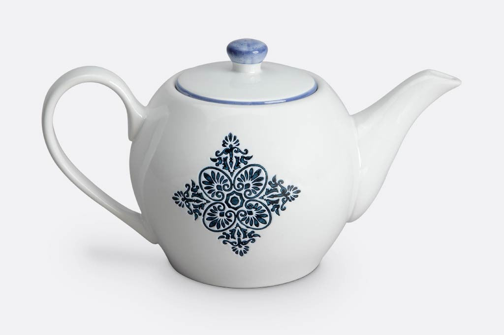 teapot of white ceramic with blue mediterranean glazed print and blue rim
