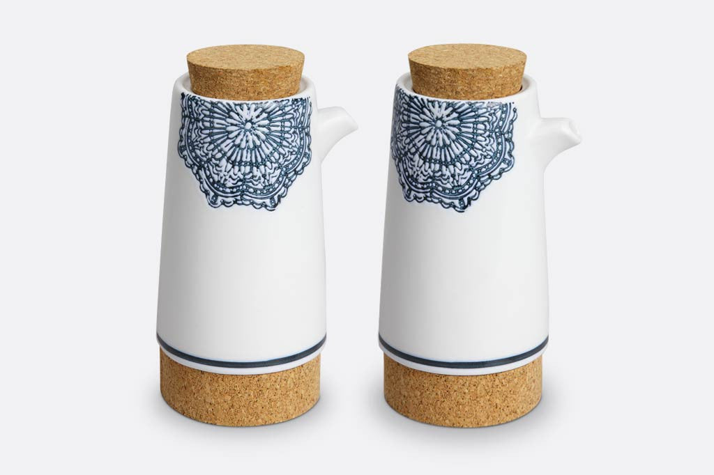 salt and pepper shaker with white ceramic with blue mediterranean glazed print and blue stripe at base