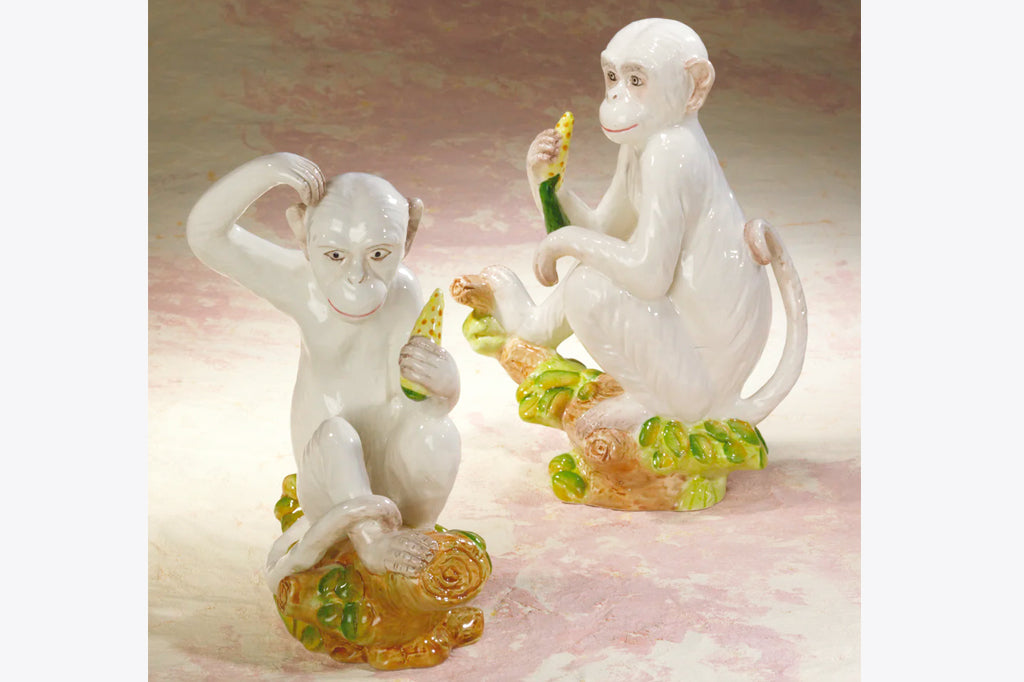 ceramic white monkey holding a banana