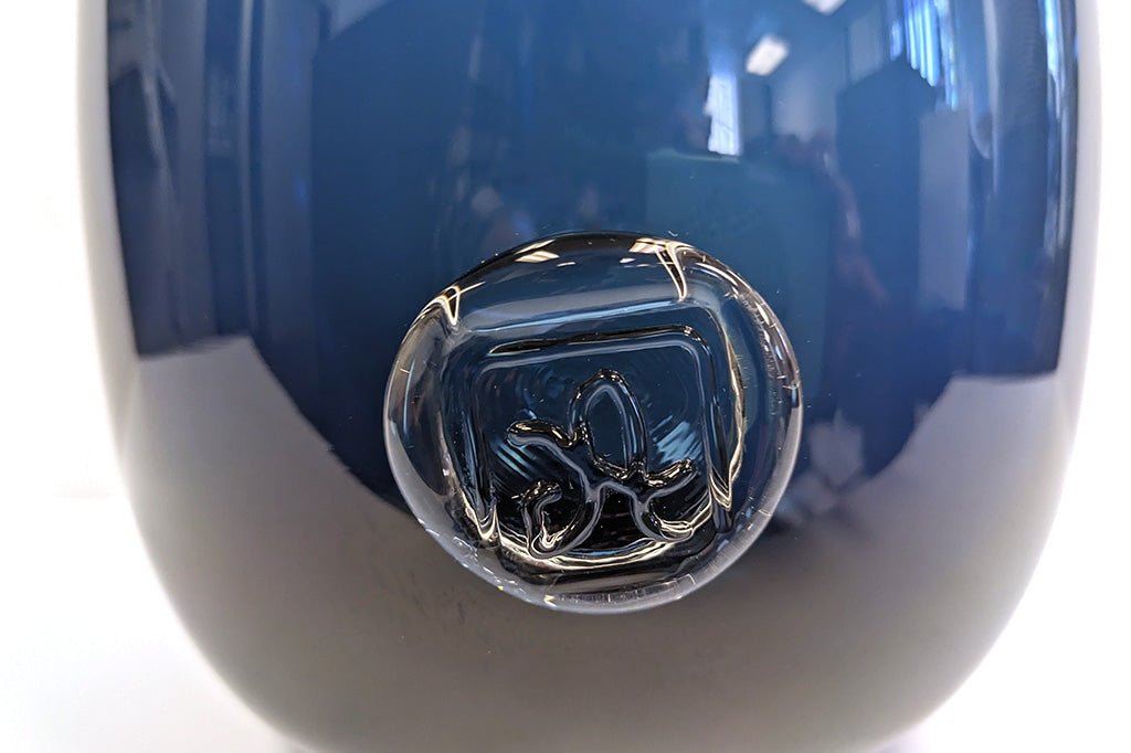 closeup view of glassmaker's mark on the vase