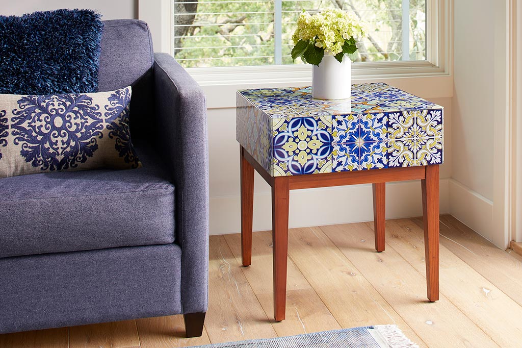 accent table with white and blue tiled table set next to couch