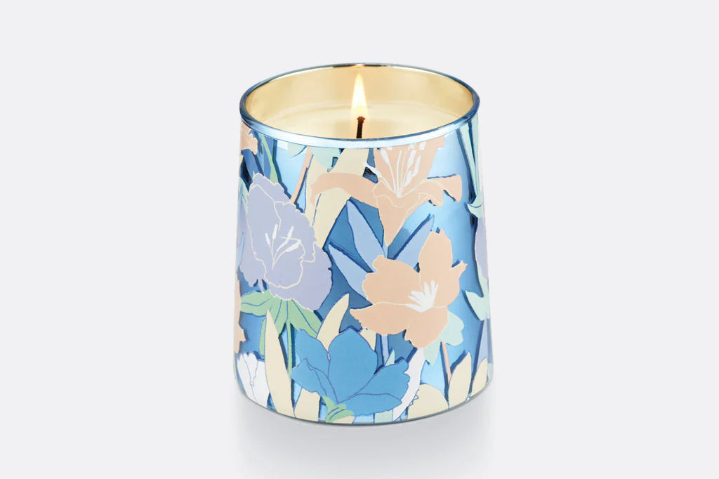 Glass candle vessel shown unlit, blue and peach floral motif