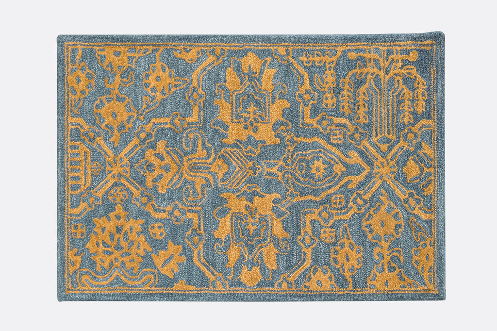 Moroccan inspired arabesques and medallions on hooked wool rug in slate blue and golden tan colors