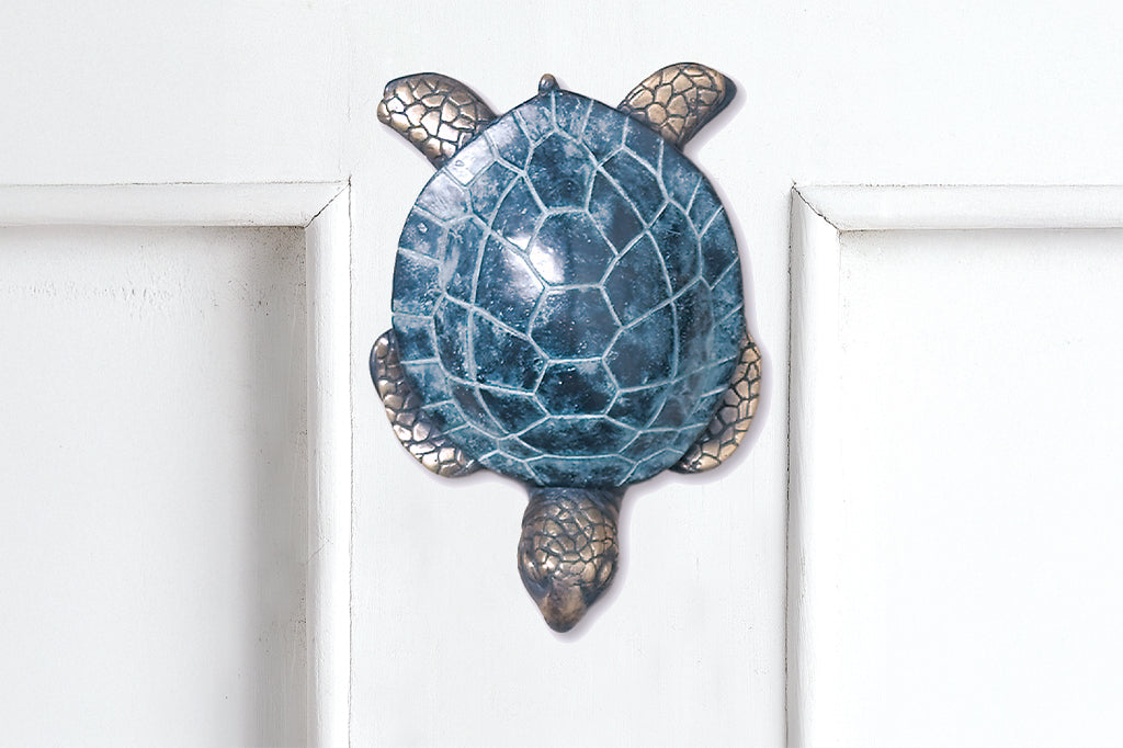 cast metal sea turtle doorknocker shown on door 