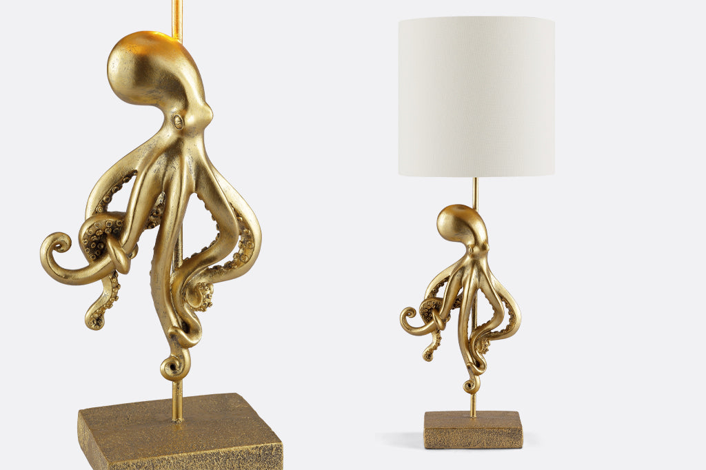 golden octopus lamp with white shade on table, close up of golden octopus see details of the winding tentacles  