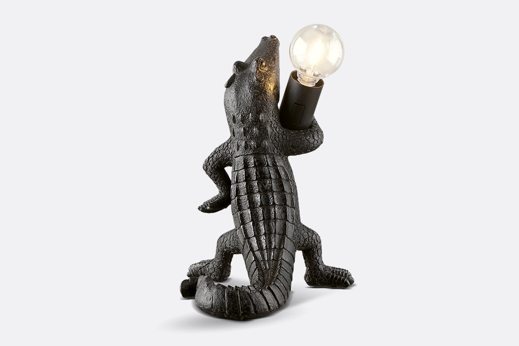 back view of black novelty desk lamp, resin alligator holding lightbulb