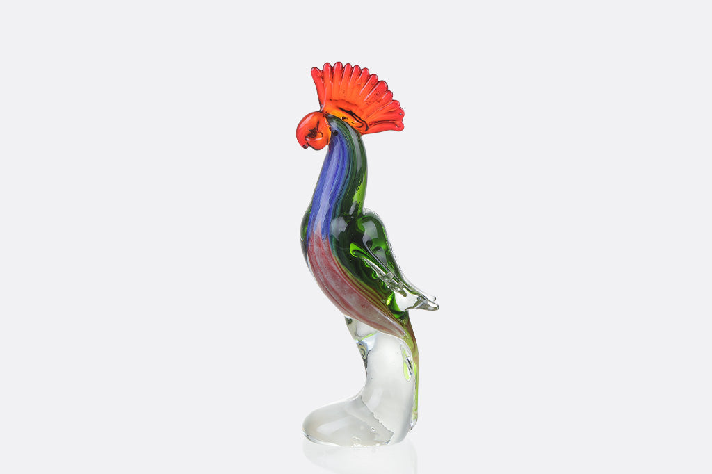 Colorful glass tropical parrot figurine on a white background