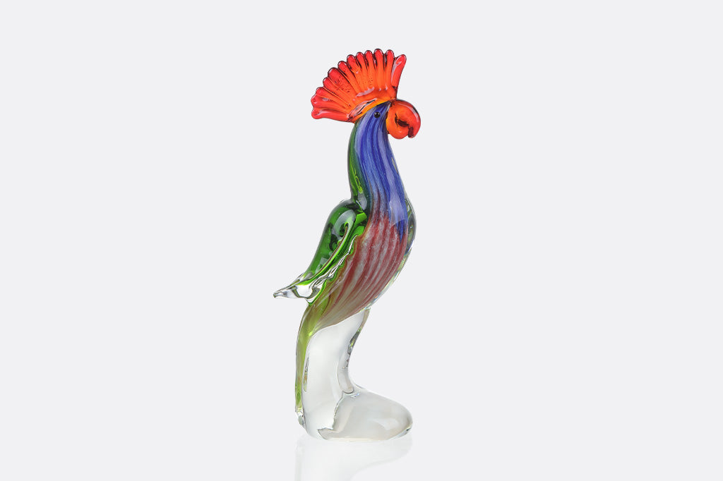 Colorful glass tropical parrot figurine on a white background