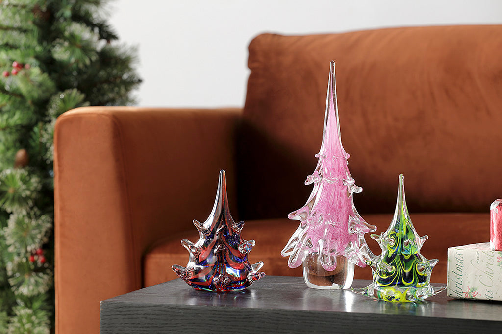 holiday table scene of three glass christmas trees in lavender, green/blue, and red/blue