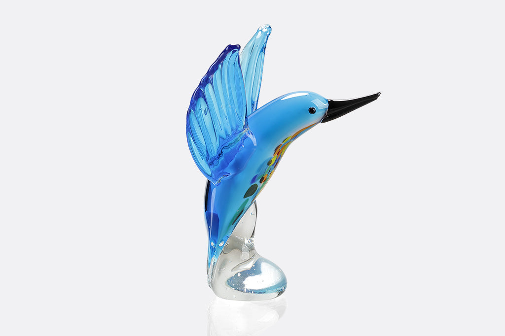 Glass blue bird figurine on a white background
